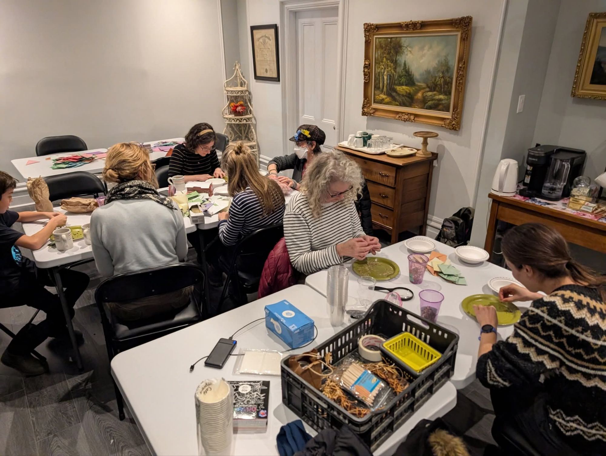 Pollinate Aylmer members packing seeds while chatting drinking tea in PSAs beautiful Aylmer House